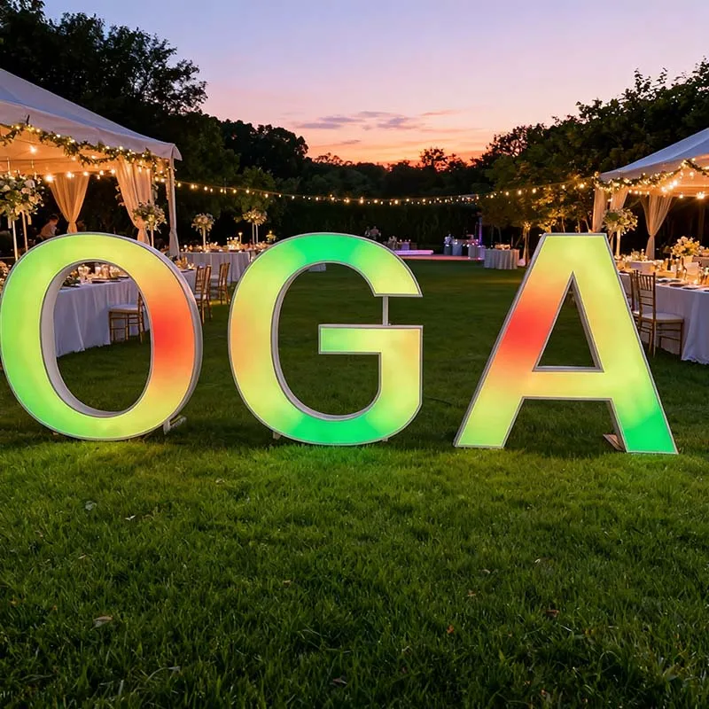 Freestanding RGB marquee letters displaying 2026 with multicolour programmed lighting effects in an LED sign factory.